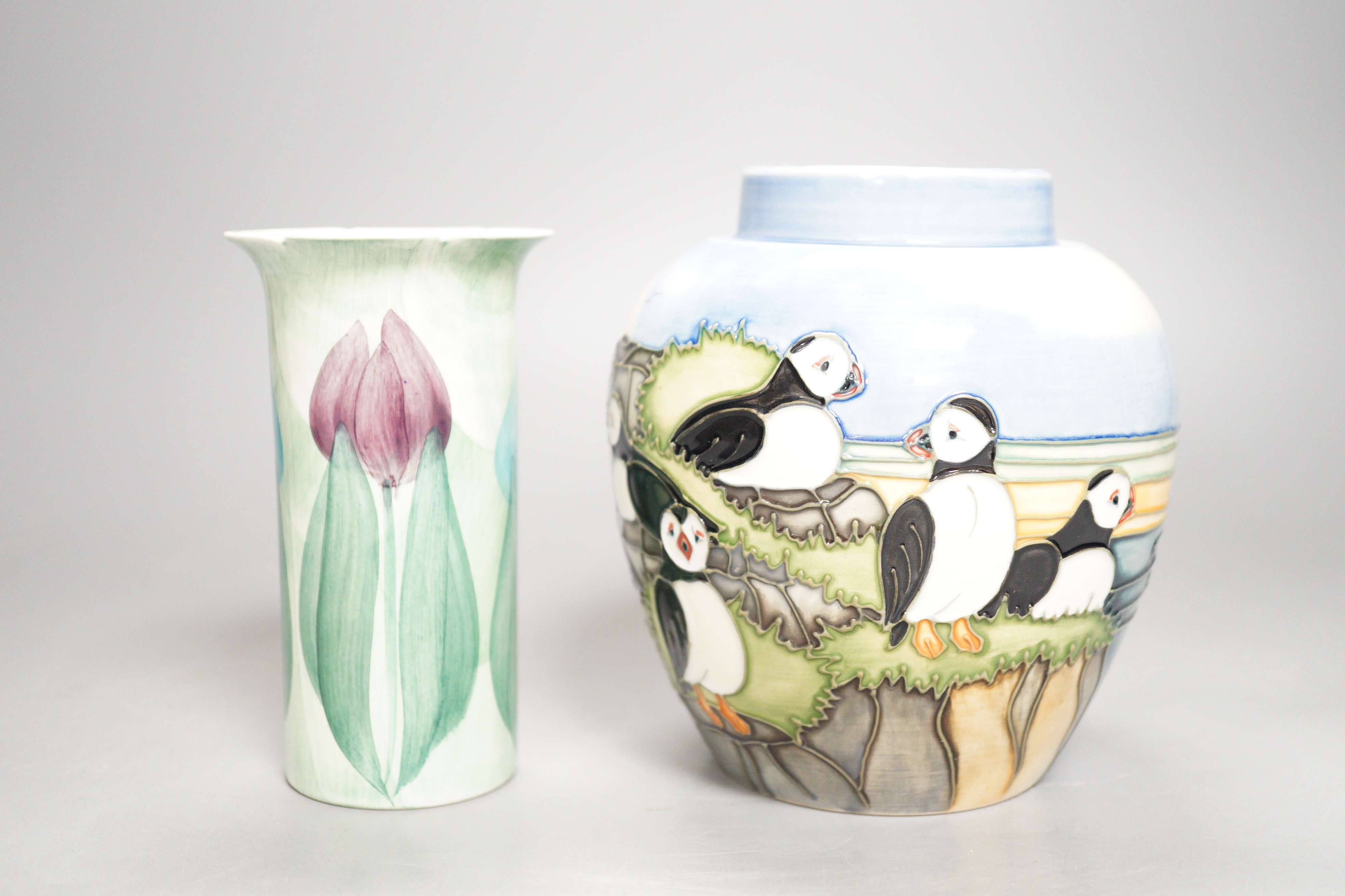 A Moorcroft pottery jar, decorated with puffins and a Jersey pottery 